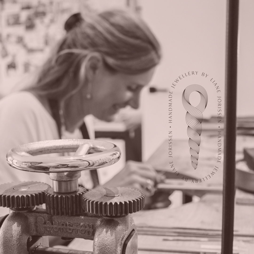 Liane Jorissen smiling & sitting at her goldsmith’s bench making beautiful jewellery. Durston rolling mill details. 